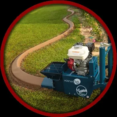 The curbing machine extruding a continuous concrete border